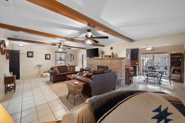 tiled living room featuring beam ceiling, a brick fireplace, and ceiling fan