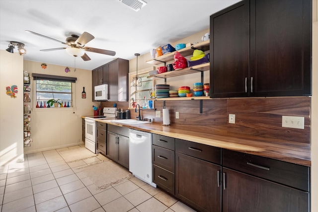 kitchen with white appliances, sink, ceiling fan, decorative light fixtures, and wooden counters