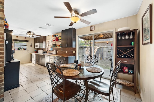 tiled dining area featuring sink and ceiling fan