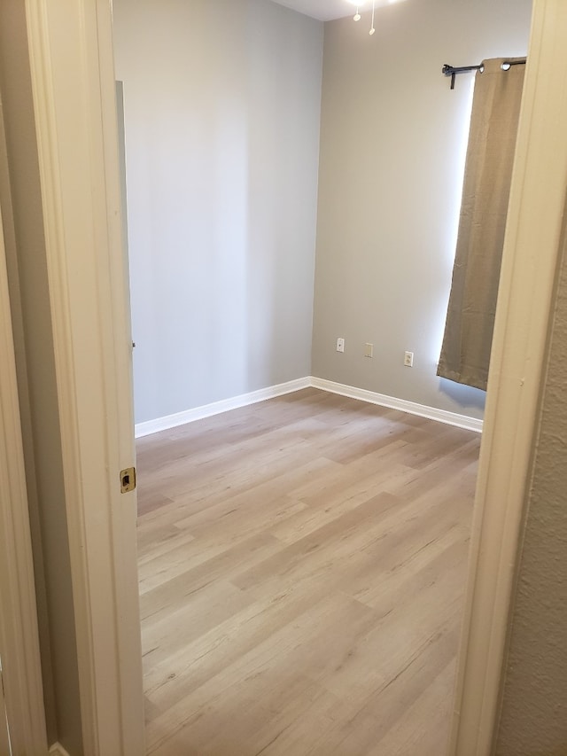 empty room with light hardwood / wood-style floors