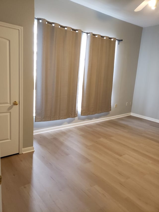 spare room featuring light hardwood / wood-style floors and ceiling fan