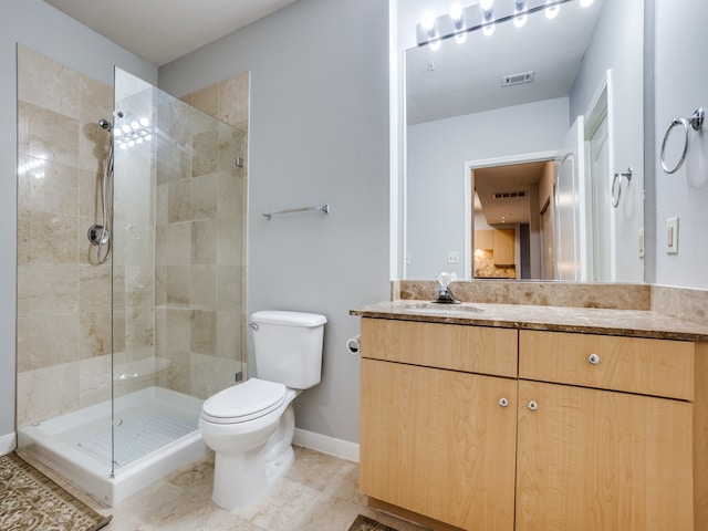 bathroom featuring vanity, tile patterned floors, toilet, and an enclosed shower