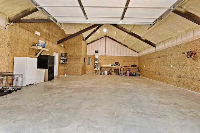 garage with white fridge and black fridge