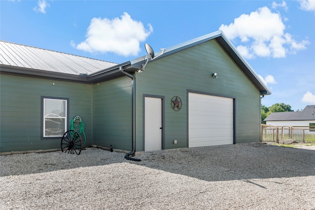 rear view of house featuring a garage