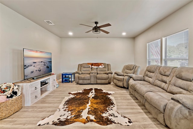 living room featuring light wood-type flooring and ceiling fan