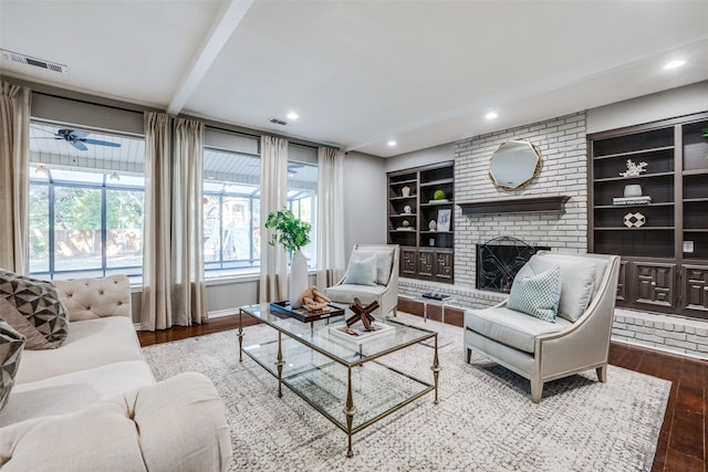 living room with a fireplace, wood-type flooring, and ceiling fan