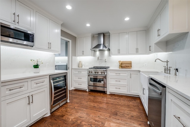 15211 Meandering Way, Dallas, TX 75248 - kitchen with wine cooler, wall chimney range hood, white cabinets, appliances with stainless steel finishes, and backsplash