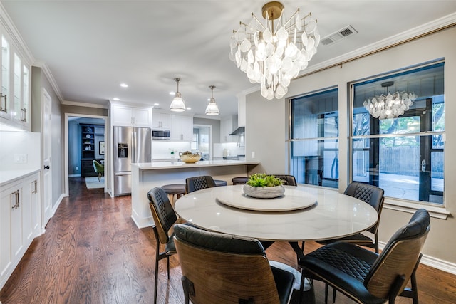 dining area with dark wood-type flooring, crown molding, and a chandelier