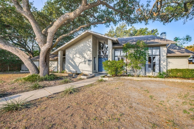 15211 Meandering Way, Dallas, TX 75248 - view of front facade with brick siding and a chimney