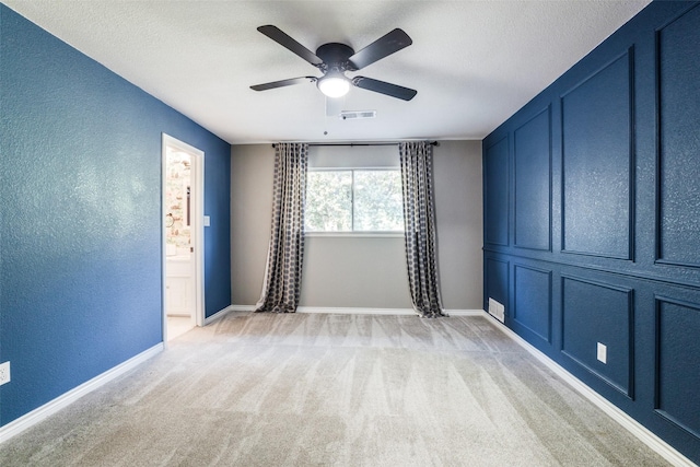 15211 Meandering Way, Dallas, TX 75248 - spare room with a textured wall, light colored carpet, a ceiling fan, baseboards, and visible vents