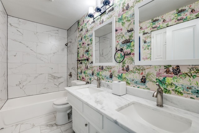 full bathroom with vanity, tiled shower / bath, and toilet