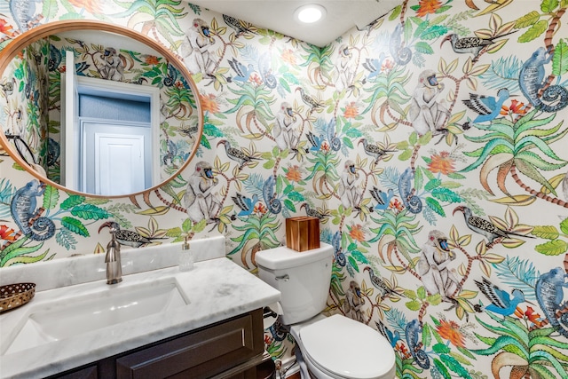 bathroom featuring toilet and vanity