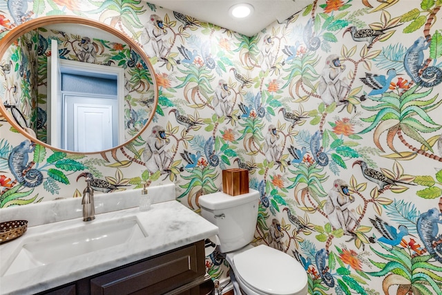 15211 Meandering Way, Dallas, TX 75248 - half bathroom featuring toilet, wallpapered walls, and vanity