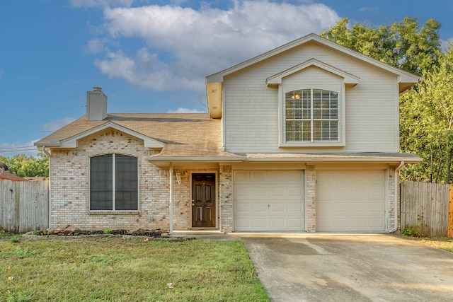 view of front of property featuring a front yard and a garage