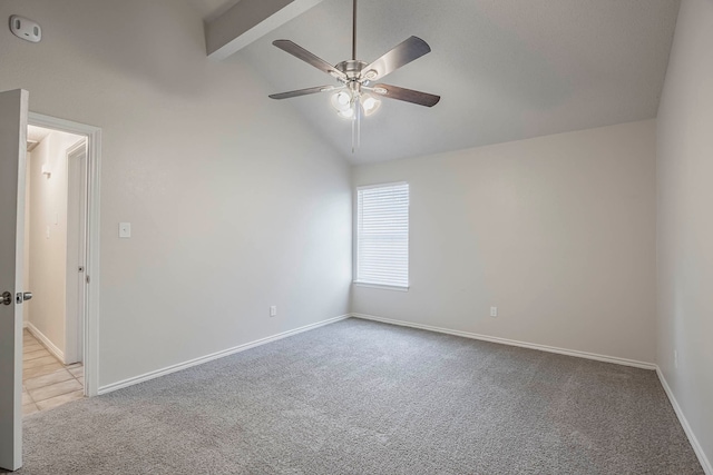 carpeted spare room with ceiling fan and lofted ceiling with beams