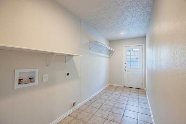 laundry room with light tile patterned floors, a textured ceiling, washer hookup, and hookup for an electric dryer