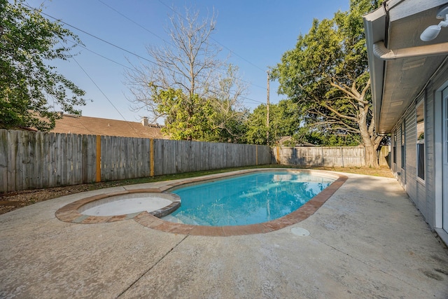 view of swimming pool with a patio and an in ground hot tub