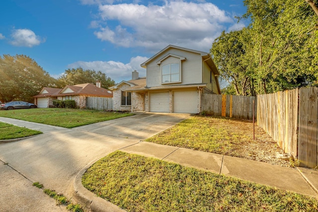 view of property with a garage and a front lawn