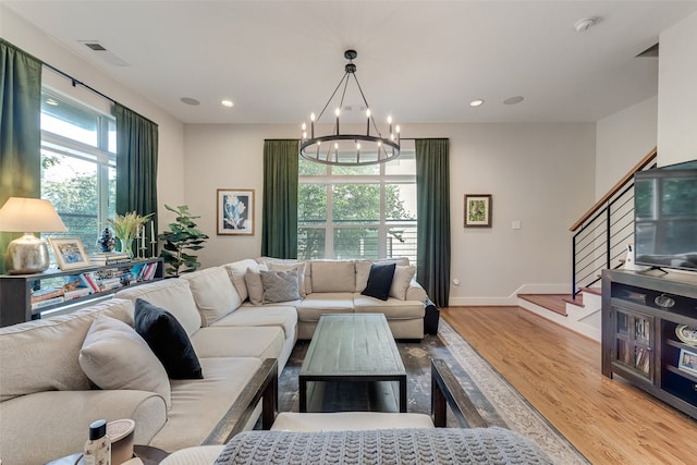 living room with a chandelier and light wood-type flooring