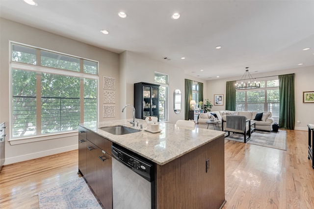 kitchen with dishwasher, an island with sink, and a healthy amount of sunlight