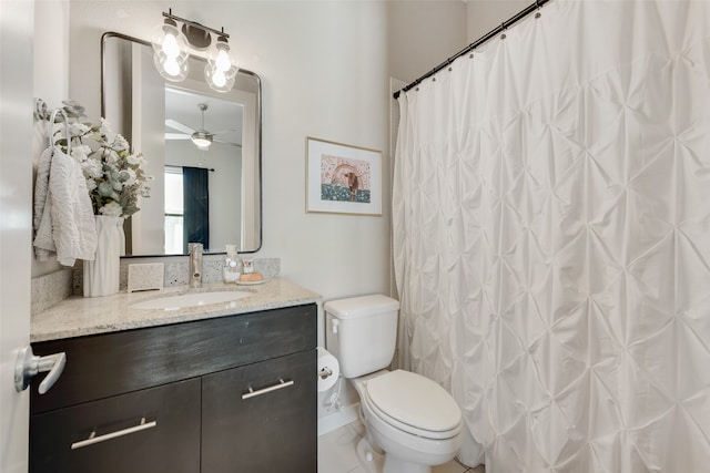 bathroom with ceiling fan, toilet, vanity, curtained shower, and tile patterned floors