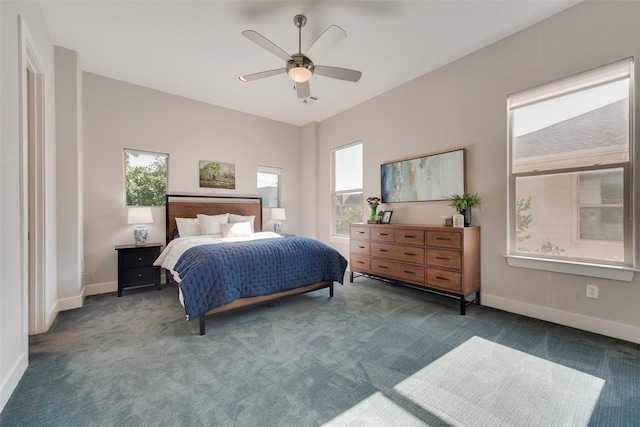 bedroom with dark colored carpet and ceiling fan