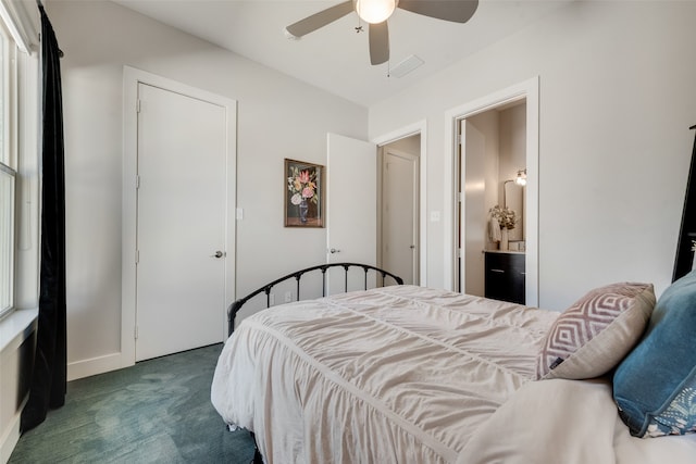 bedroom with dark colored carpet, ensuite bathroom, and ceiling fan