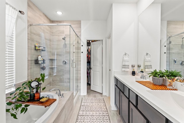 bathroom featuring vanity and shower with separate bathtub