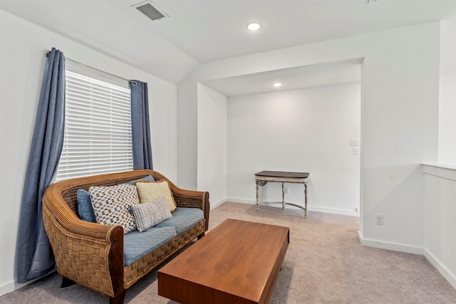 sitting room with light colored carpet and vaulted ceiling