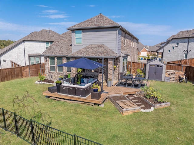 back of property with a wooden deck, an outdoor living space, a yard, and a storage shed