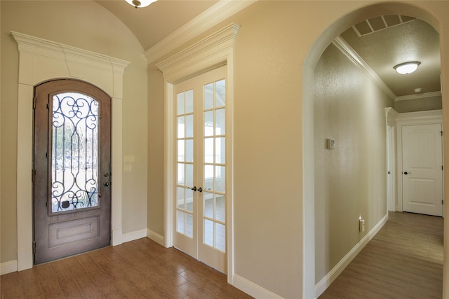 entrance foyer featuring crown molding, french doors, and hardwood / wood-style flooring