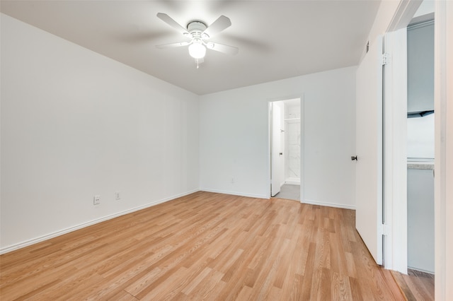 empty room featuring light wood-type flooring and ceiling fan