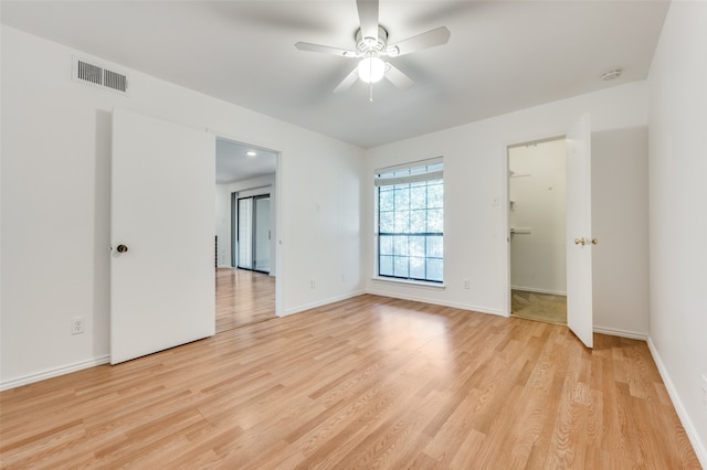 empty room with light hardwood / wood-style flooring and ceiling fan