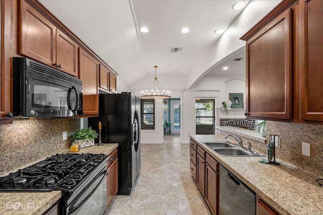 kitchen featuring black appliances, sink, vaulted ceiling, decorative backsplash, and a chandelier