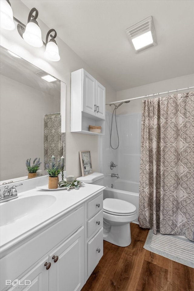 full bathroom with shower / tub combo with curtain, vanity, wood-type flooring, and toilet