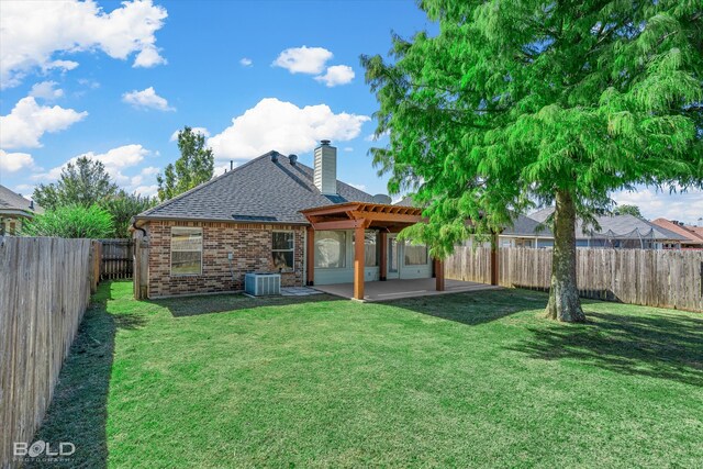 rear view of property featuring a patio area, central air condition unit, and a lawn