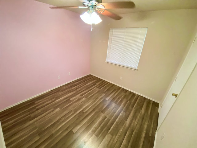 empty room featuring ceiling fan and dark hardwood / wood-style flooring