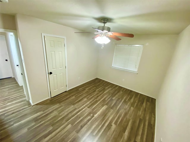 unfurnished bedroom with dark hardwood / wood-style floors, a closet, and ceiling fan