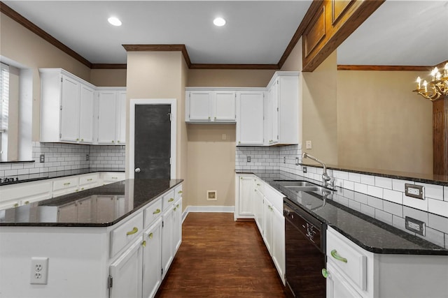 kitchen with dark hardwood / wood-style flooring, ornamental molding, dark stone countertops, dishwasher, and white cabinetry