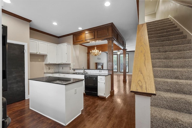 kitchen with dishwasher, dark wood-type flooring, white cabinets, crown molding, and ornate columns