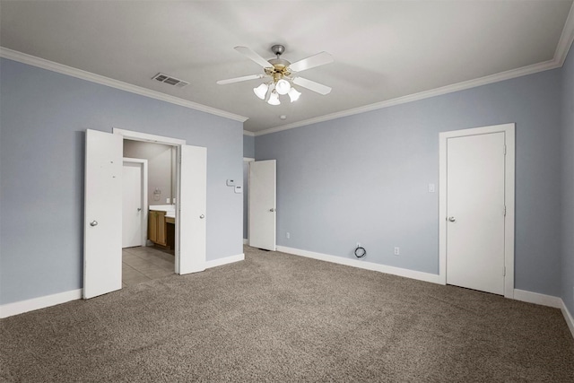 unfurnished bedroom featuring ensuite bath, ceiling fan, crown molding, and light colored carpet