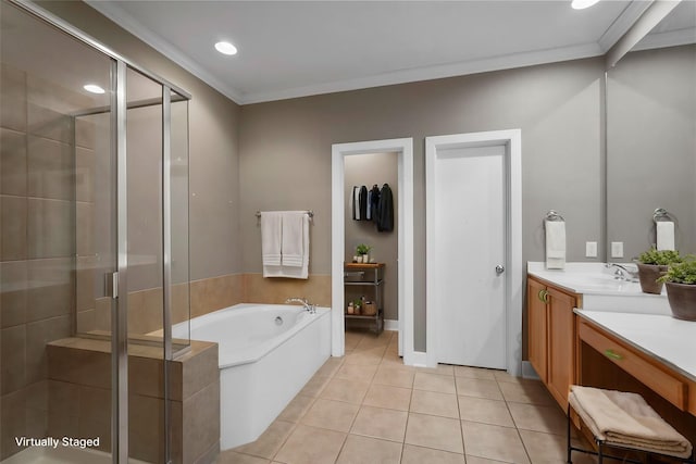 bathroom with tile patterned floors, vanity, ornamental molding, and shower with separate bathtub