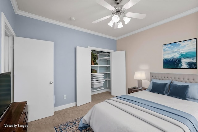 carpeted bedroom featuring a closet, ceiling fan, and crown molding