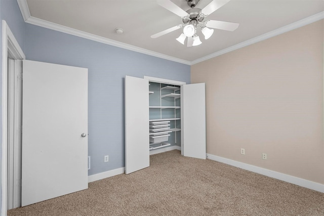 unfurnished bedroom featuring carpet floors, a closet, ceiling fan, and crown molding