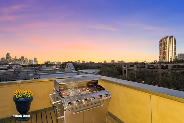 patio terrace at dusk featuring area for grilling