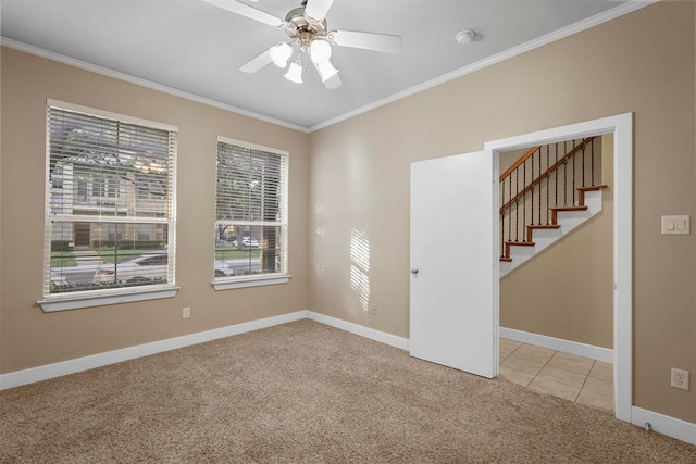 carpeted spare room featuring ceiling fan and crown molding