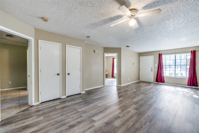 unfurnished room featuring hardwood / wood-style floors, a textured ceiling, and ceiling fan