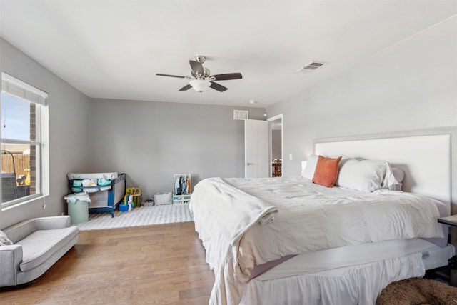 bedroom with ceiling fan and light hardwood / wood-style flooring