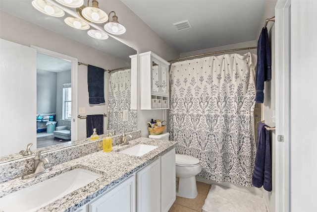 bathroom with tile patterned floors, vanity, curtained shower, and toilet