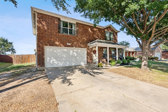 view of property featuring a porch and a garage